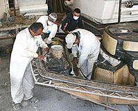 Applying fiberglass to a boat mold.