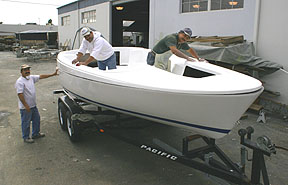 FinCo employees  finish work on a LEAR204 deck and hull.