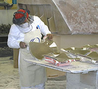 A FinCo employ creates a fiberglass Mag-Vest body.