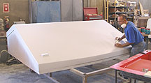 Sanding a fiberglass product.
